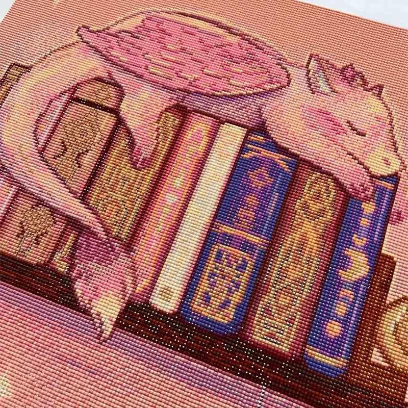 Diamond Painting Leinwand mit Büchern und Drachen Motiv mit glitzernden Steinchen