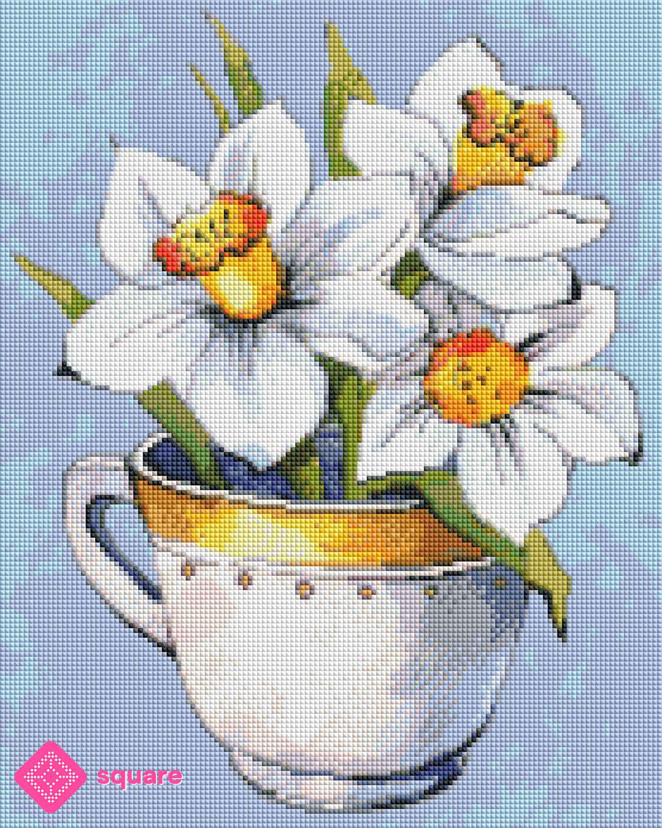 Diamond Painting Vorschau mit zarten Narzissen in Weiß und Gelb, liebevoll in einer weißen Tasse mit gelbem Rand arrangiert, in funkelnder Steinoptik